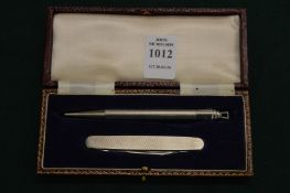 A cased propelling pencil and penknife set.