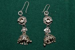 A pair of decorative earrings.