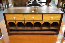 A mahogany and satin wood table top stationery cabinet with pigeon holes and small drawers.