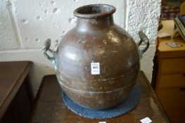 A copper twin handled vessel.