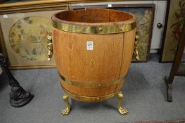 A brass bound oak coal bucket or jardiniere on paw feet.