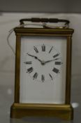 A brass carriage clock with alarm.