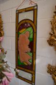 A stained glass leaded panel depicting an Art Nouveau style lady.