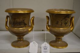 A pair of gilt decorated porcelain twin handled pedestal vases decorated with sheep and other