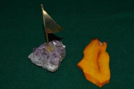 Decorative amethyst paperweight set with a brass sail together with a piece of amber (?).