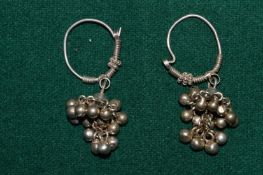 A pair of decorative earrings.