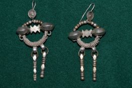 A pair of decorative earrings.