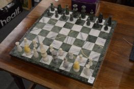 An alabaster chess set with board.