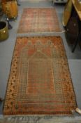 Two old worn Persian rugs, 155cm x 100cm and 130cm x 106cm.