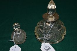 Two silver mounted cut glass scent bottles.