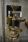 A silver photograph frame, two plated goblets and a plated candlestick.
