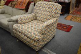 In the manner of Howard & Sons, an upholstered armchair.