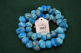 A turquoise glazed bead necklace.