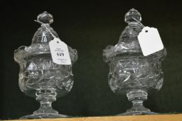 A pair of cut glass pedestal bowls and covers.