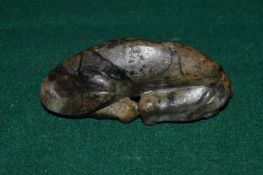 Chinese carved hard stone model of a recumbent horse.