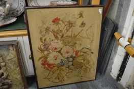 A wool work picture depicting flowers and a birds nest.
