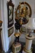 A floor standing Blackamoor candelabra.