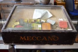 A Meccano tabletop display case with accessories (badly worm damaged).