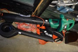 A Black and Decker garden leaf blower/vacuum with accessories.