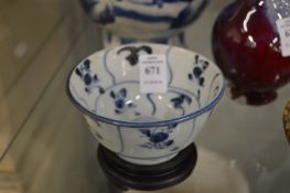 A small blue and white porcelain bowl and stand.
