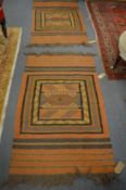 Two small ethnic rugs, 132cm x 78cm and 125cm x 75cm.
