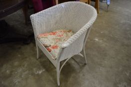 A Lloyd loom chair and another similar chair.