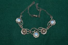 A decorative necklace set with moon stones.