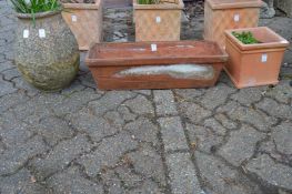 Three terracotta planters.