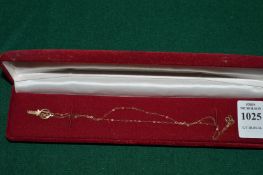 A 9ct gold coming of age key pendant and fine chain.