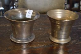 Two plain bronze mortars.