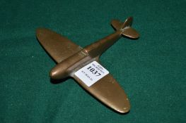 A small bronze model of a Spitfire.