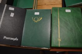 Three albums containing World stamps.