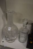 A large cut glass six compartment decanter and another decanter.