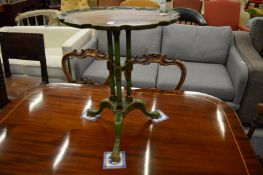 A green painted tripod table.