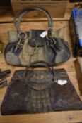 Two alligator skin handbags.