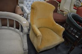 A Victorian gold draylon upholstered armchair.