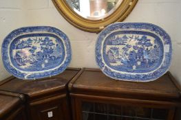 A pair of blue and white willow pattern dishes.
