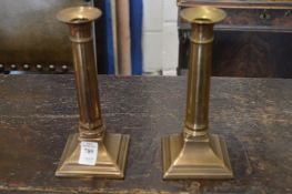 A pair of brass candlesticks.