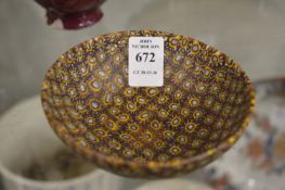 An Islamic amber and blue glass circular bowl.