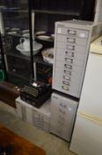 Four small Bisley metal filing cabinets.