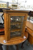 An oak hanging corner display cabinet.