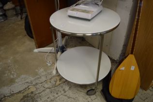 A stylish chrome and opaque glass circular two-tier trolley.