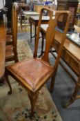 A set of four mahogany high back dining chairs.