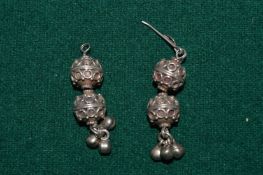 A pair of decorative earrings.