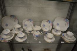 A Shelly twelve place tea service decorated with blue and pink flowers.