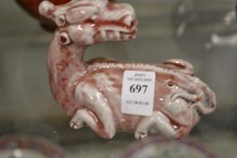 A Chinese pottery brush rest in the form of a dragon.
