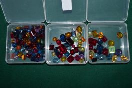 Three boxes of colourful stones.