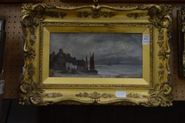 Continental School, fishing boats moored by a cottage, oil on canvas, in a decorative gilt frame.