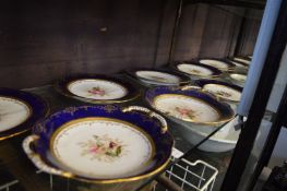 A Coalport floral decorated dessert service comprising twelve plates and two pairs of dishes.
