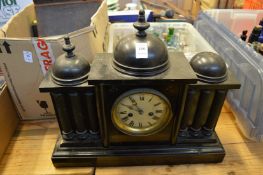 An ebonised mantel clock.